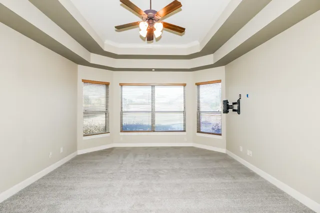 a large bathroom with a large mirror vanity and a sink