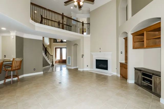 a view of a hallway with wooden floor and a chandelier