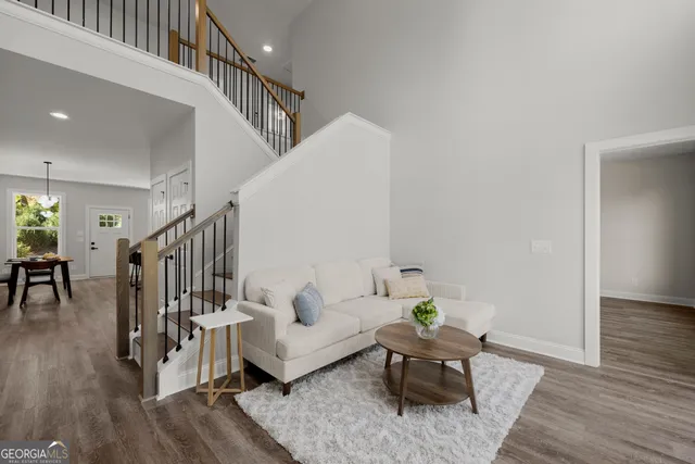 a living room with furniture and wooden floor
