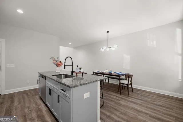 a kitchen with granite countertop a sink and stove in it