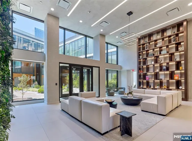 a living room with furniture a rug and white walls