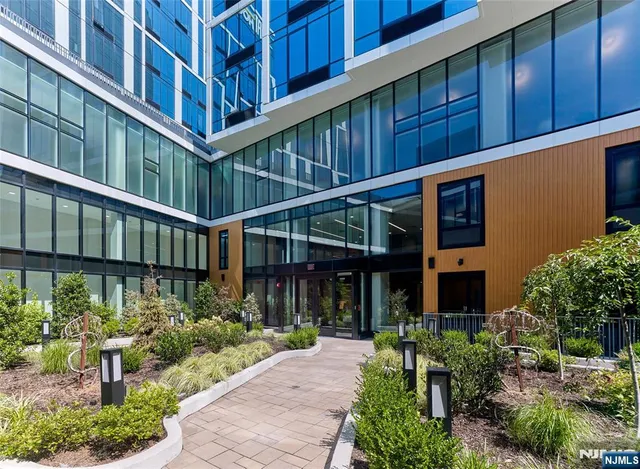 a front view of a building with a garden