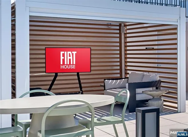 a view of a chairs and table in the balcony