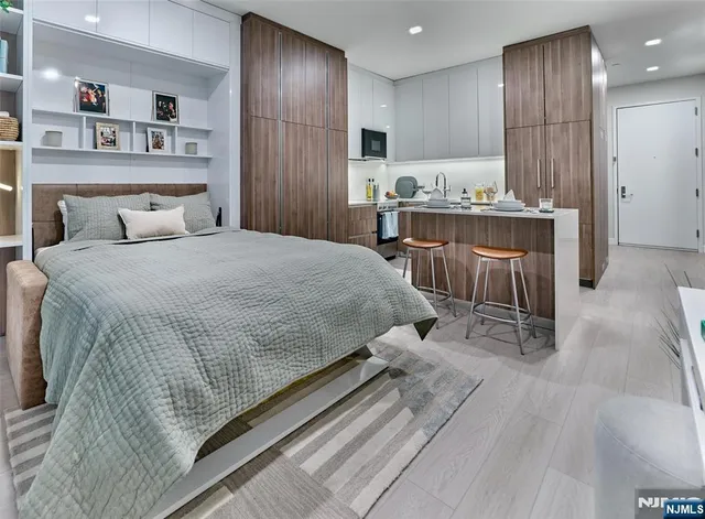 a spacious bedroom with a bed and a book shelf