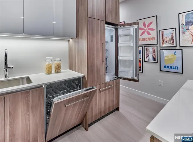 a kitchen with stainless steel appliances granite countertop a sink and cabinets