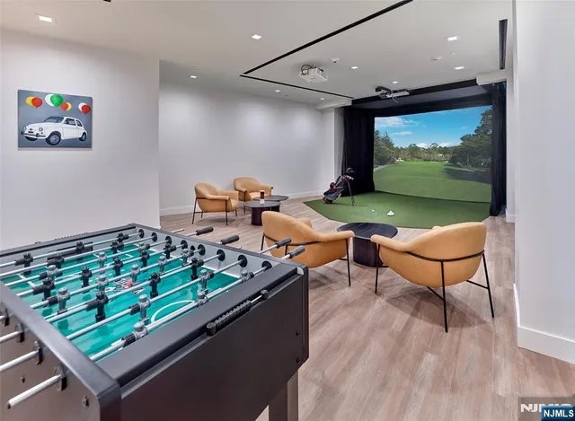 an outdoor room with chairs pool and wooden floor