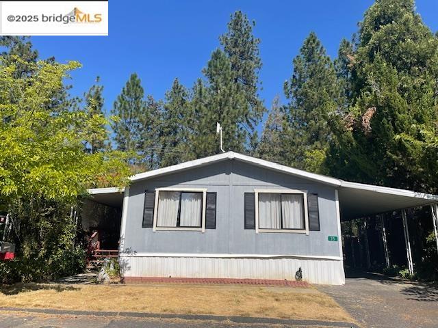 22217 Parrotts Ferry Road, Unit 35 Sonora, CA 95370 - Photo 1 of 1 Manufactured / mobile home with asphalt driveway and an attached carport