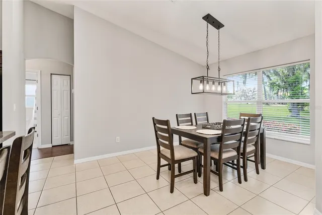 a bathroom with a granite countertop double vanity sink a mirror and a bathtub