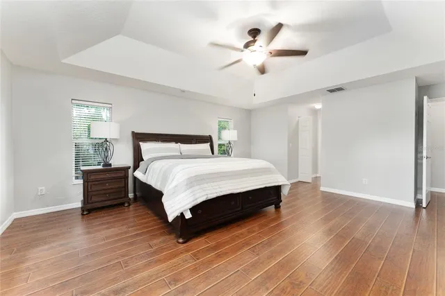 a bathroom with a sink a toilet a mirror and shower