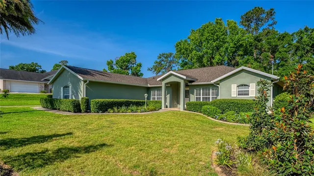 a living room with patio furniture and a flat screen tv