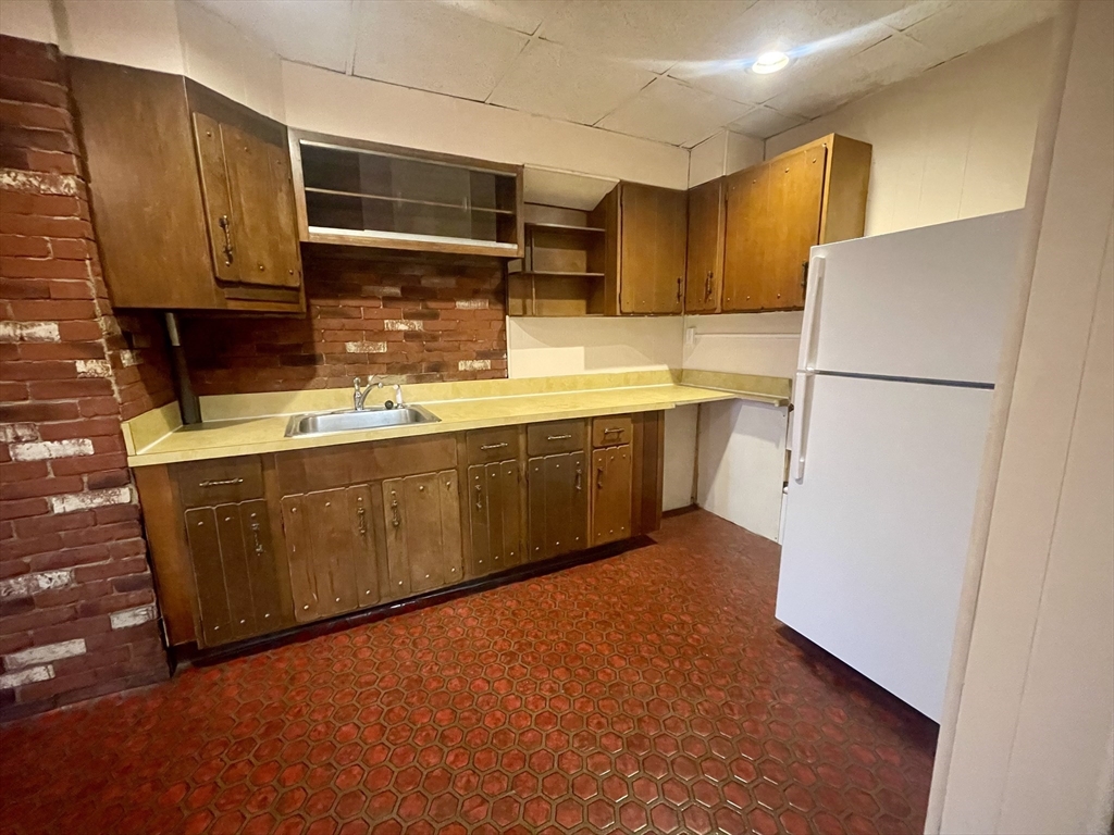 136 Saratoga Street, Unit 2 Boston, MA 02128 - Photo 12 of 19 a kitchen with stainless steel appliances a sink and a refrigerator