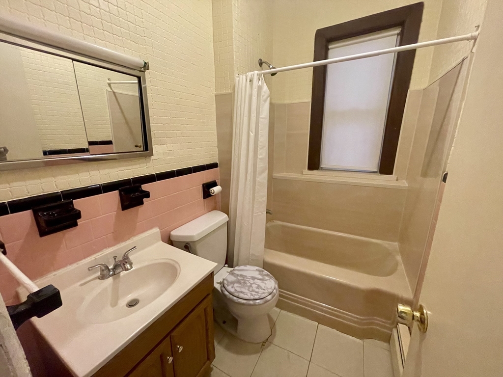 136 Saratoga Street, Unit 2 Boston, MA 02128 - Photo 18 of 19 a bathroom with a sink and a mirror
