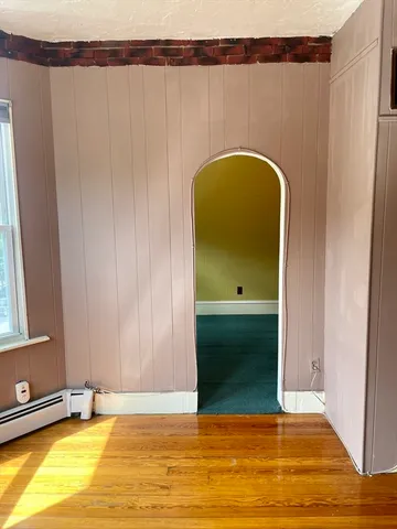 a view of a room with wooden floor and stairs