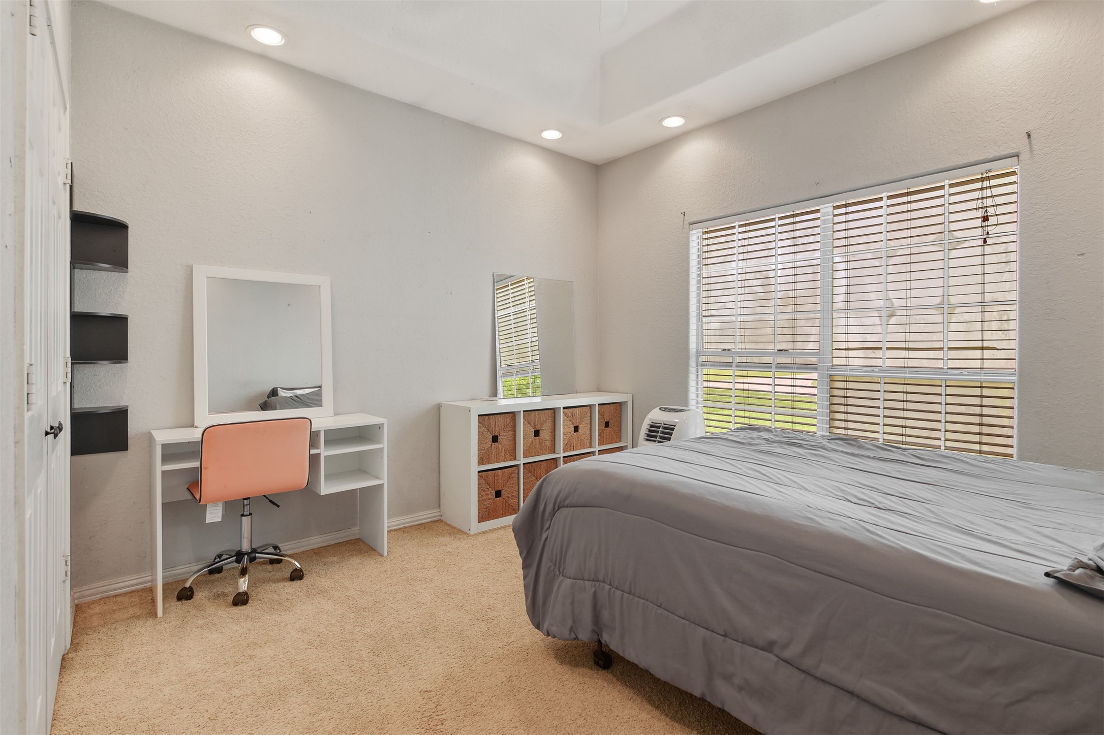 11692 Clark Lane Conroe, TX 77385 - Photo 17 of 35 Additional secondary bedroom features carpet, tray ceiling with ceiling fan and large picture window.
