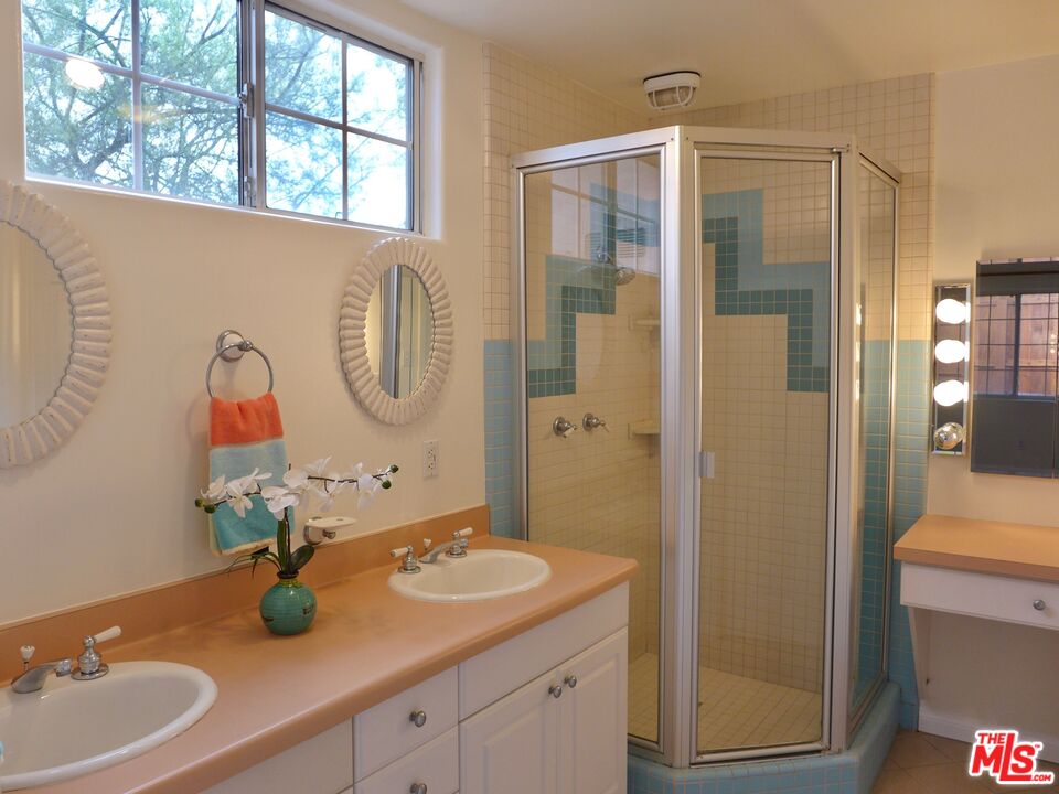 3124 Veteran Avenue Los Angeles, CA 90034 - Photo 12 of 23 a bathroom with a granite countertop sink and a mirror