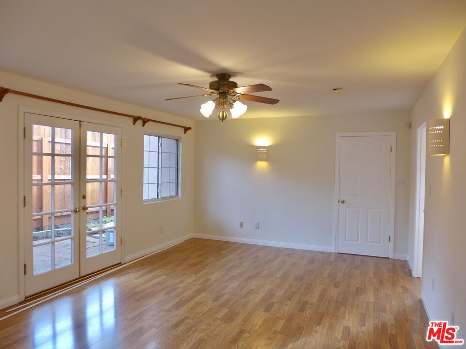 3124 Veteran Avenue Los Angeles, CA 90034 - Photo 13 of 23 a view of empty room with wooden floor and fan