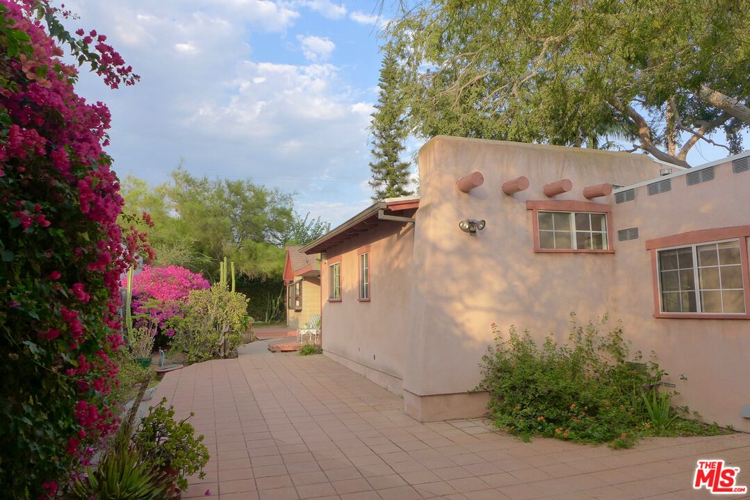 3124 Veteran Avenue Los Angeles, CA 90034 - Photo 10 of 23 a front view of a house with a yard and a fountain