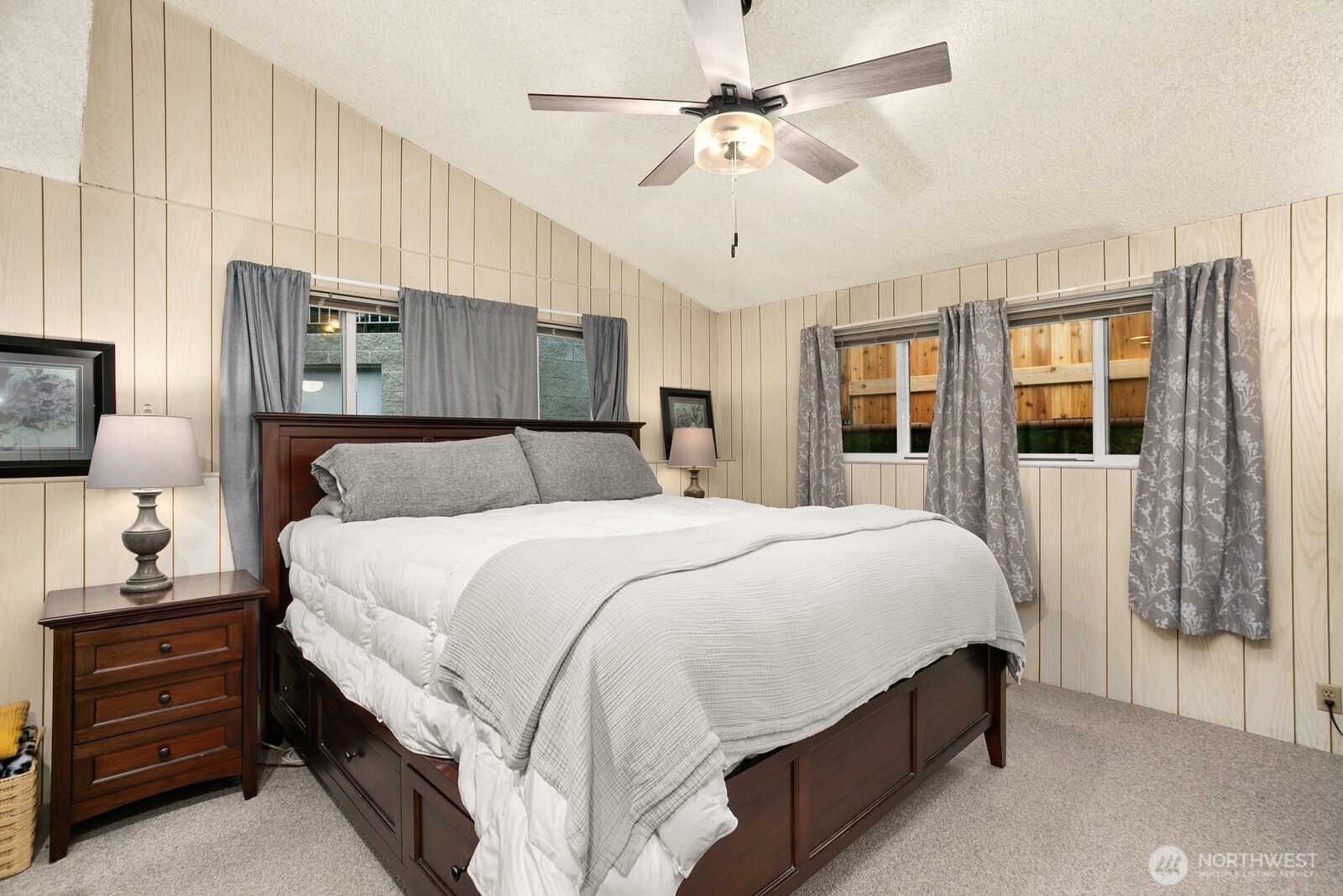 3542 43rd Avenue West Seattle, WA 98199 - Photo 11 of 39 a bedroom with a large bed and a chandelier