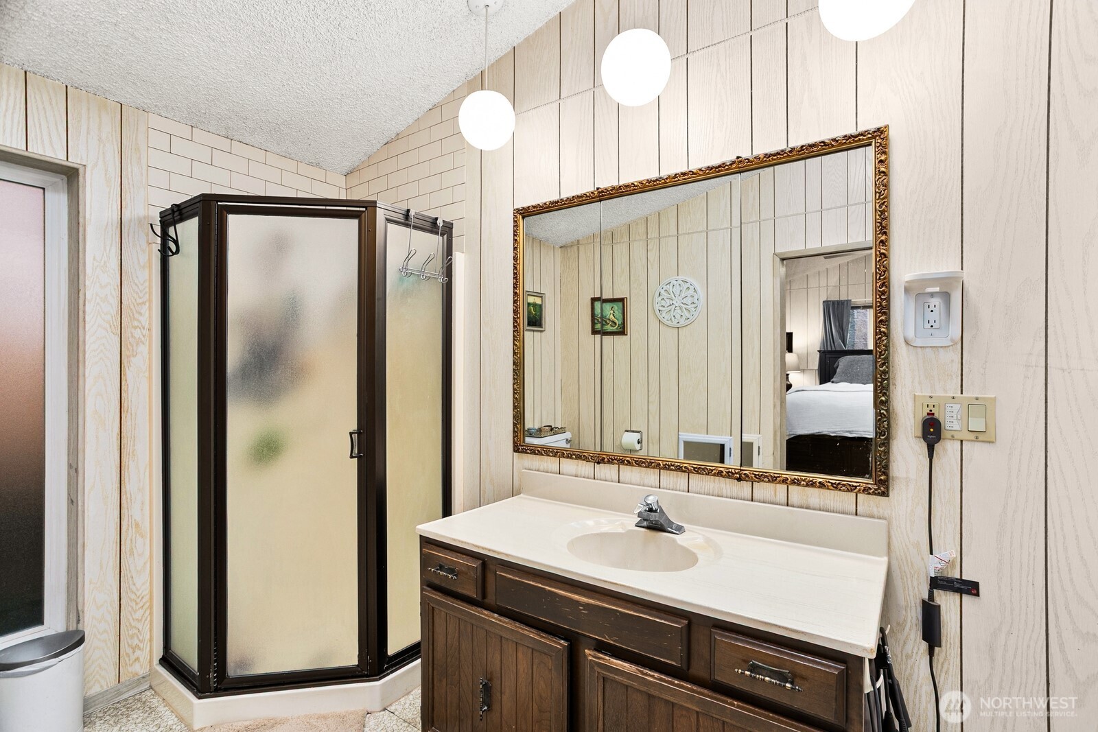 3542 43rd Avenue West Seattle, WA 98199 - Photo 13 of 39 a bathroom with a sink a mirror and a shower