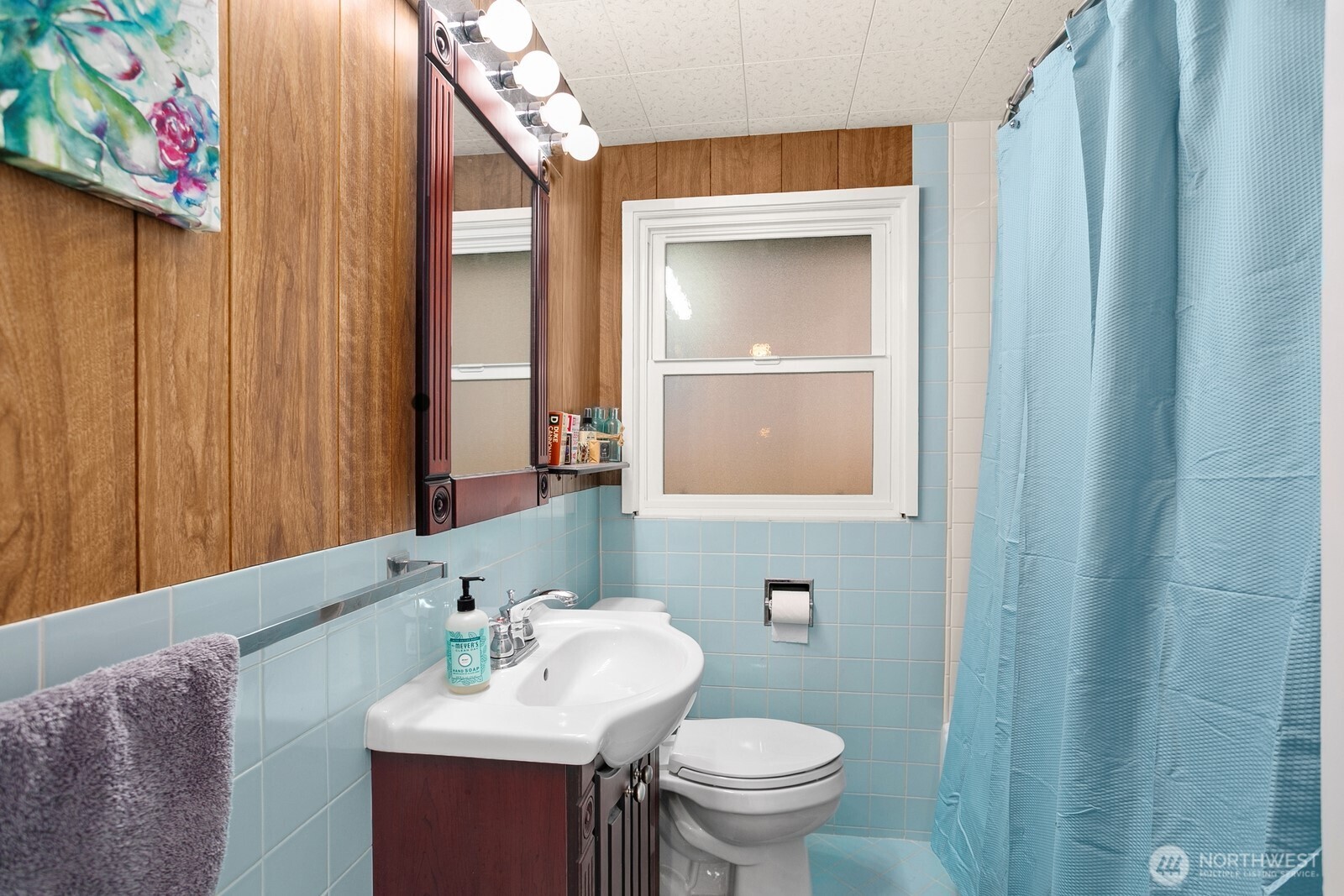3542 43rd Avenue West Seattle, WA 98199 - Photo 18 of 39 a bathroom with a sink a toilet and mirror