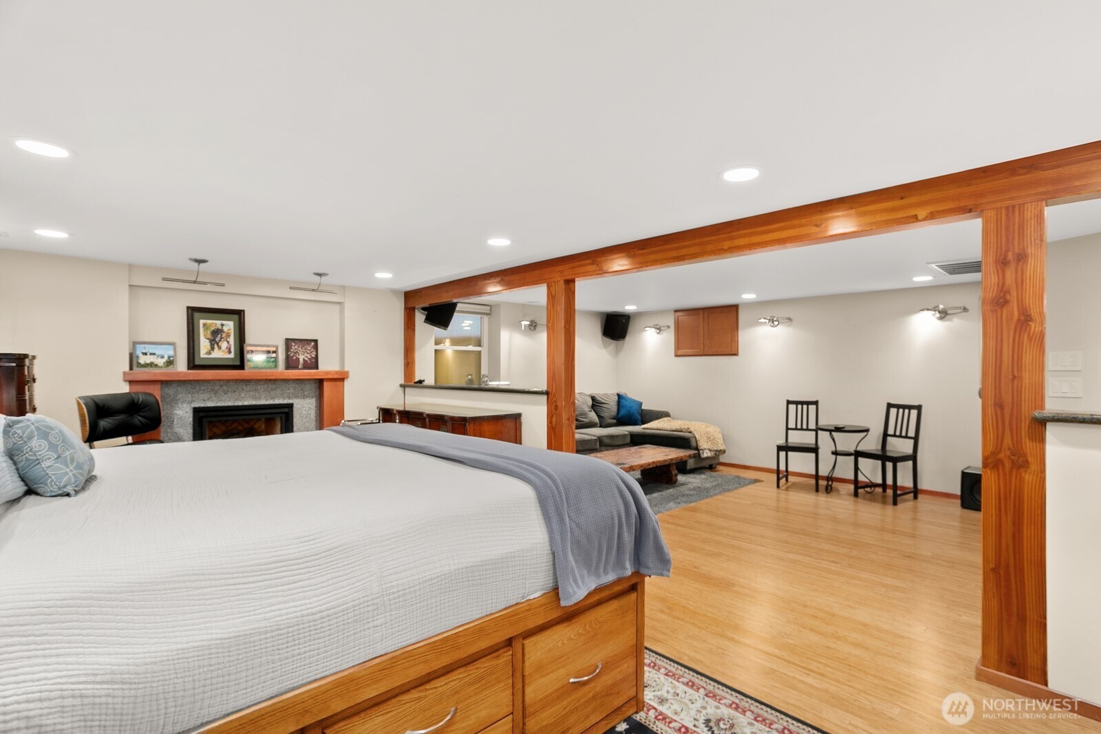 3542 43rd Avenue West Seattle, WA 98199 - Photo 21 of 39 a bedroom with a bed a table and chairs with wooden floor