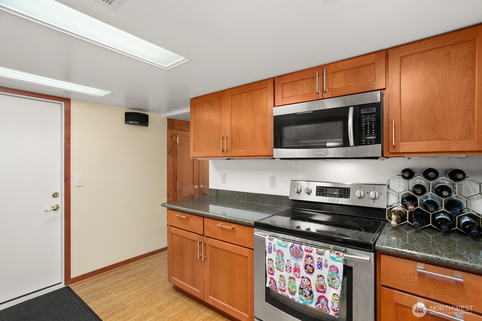 3542 43rd Avenue West Seattle, WA 98199 - Photo 24 of 39 a kitchen with stainless steel appliances granite countertop a stove microwave and sink