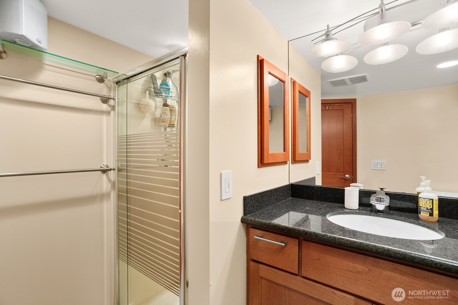 3542 43rd Avenue West Seattle, WA 98199 - Photo 26 of 39 a bathroom with a granite countertop sink and a mirror