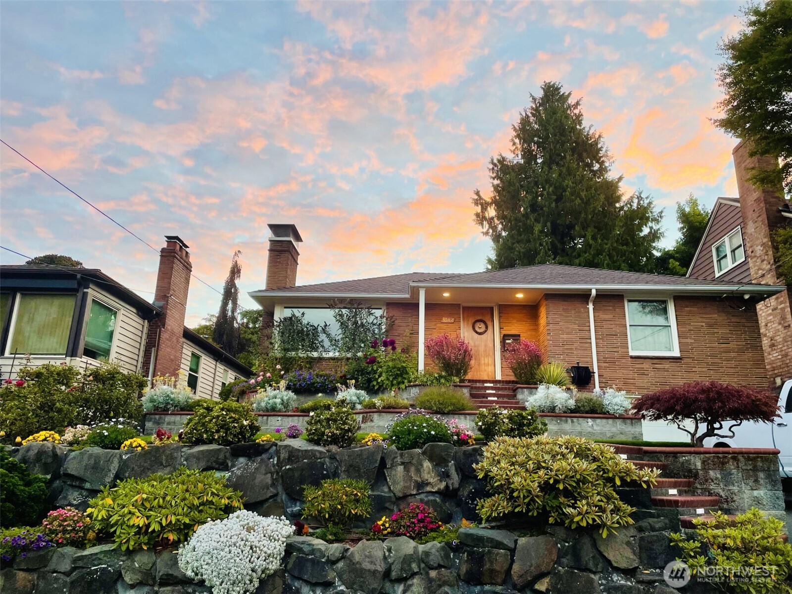 3542 43rd Avenue West Seattle, WA 98199 - Photo 38 of 39 a front view of a house with a yard and potted plants