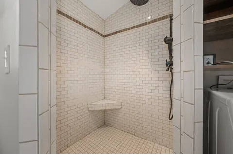 a bathroom with a toilet and a shower