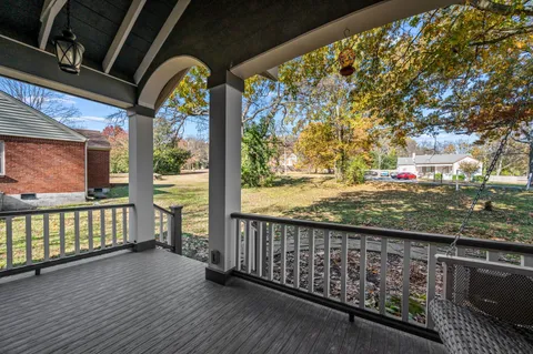a view of a porch with wooden floor and outdoor space