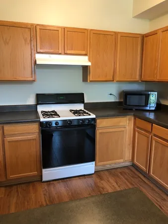 a kitchen with granite countertop a stove and a cabinets
