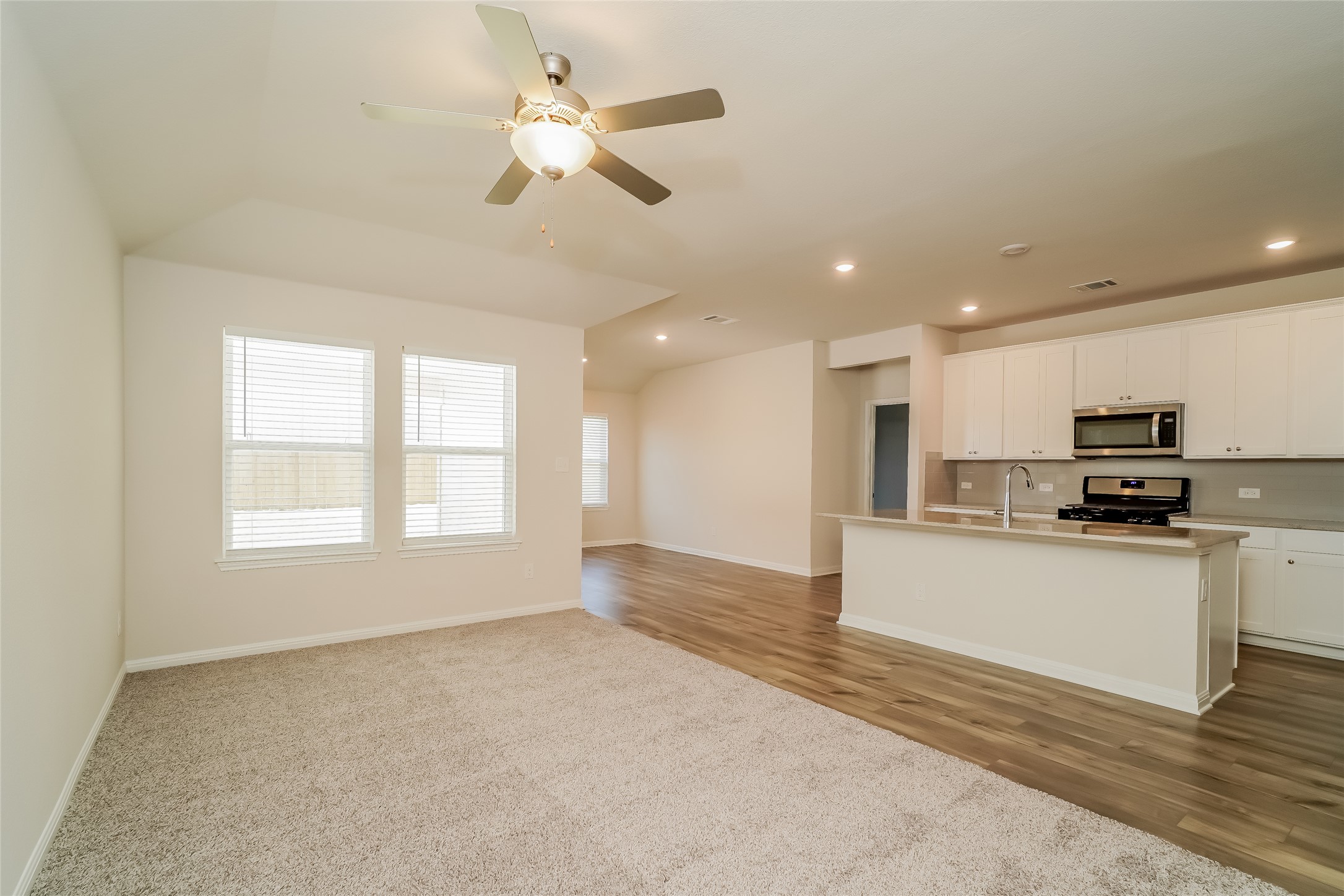 200 Babblebrook Way Hutto, TX 78634 - Photo 3 of 16 a kitchen with stainless steel appliances granite countertop a sink a stove and a refrigerator
