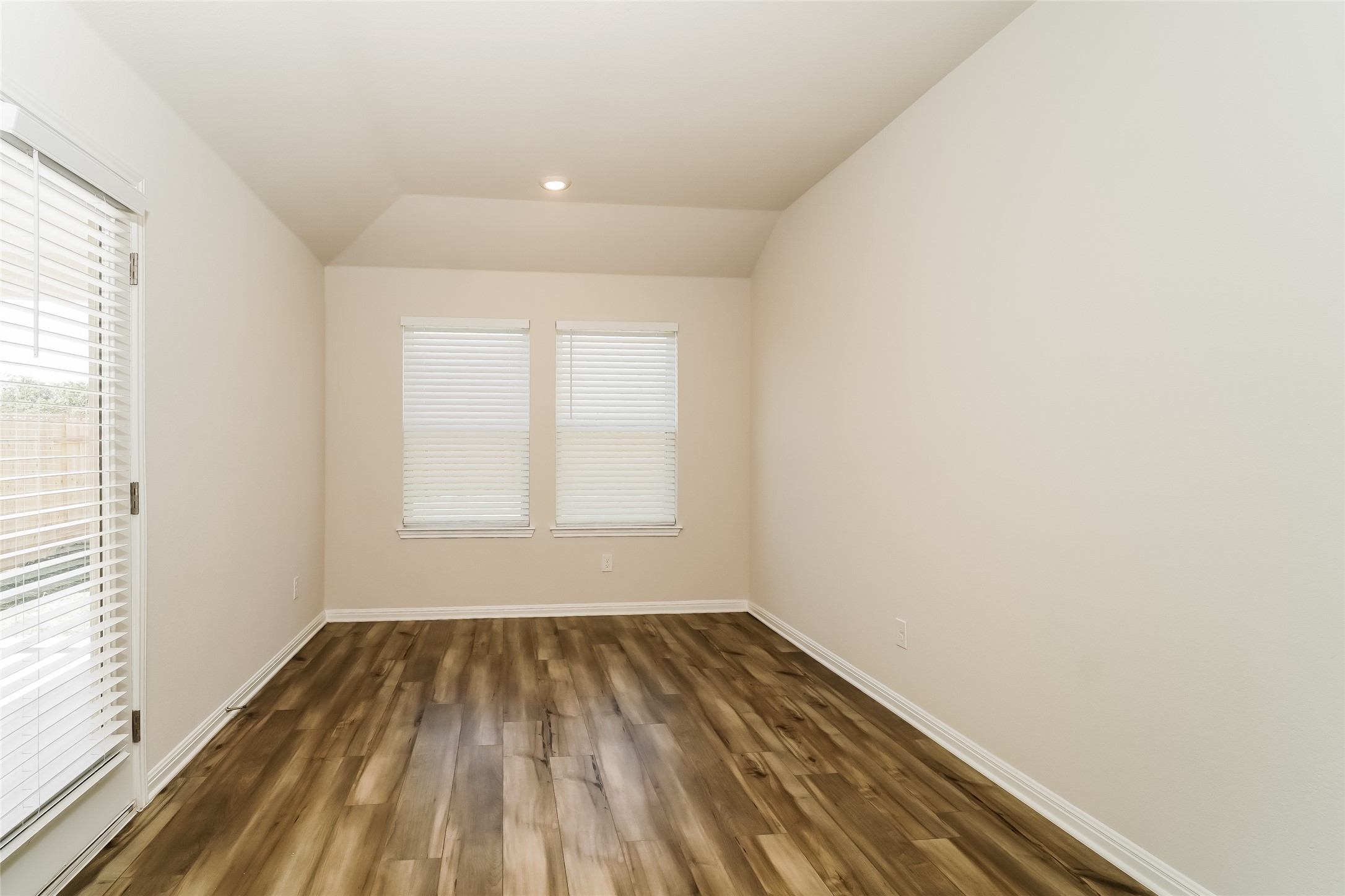 200 Babblebrook Way Hutto, TX 78634 - Photo 6 of 16 an empty room with wooden floor and windows