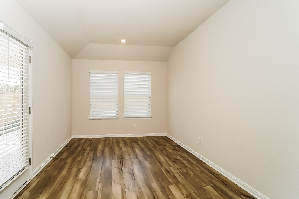200 Babblebrook Way Hutto, TX 78634 - Photo 6 of 16 an empty room with wooden floor and windows