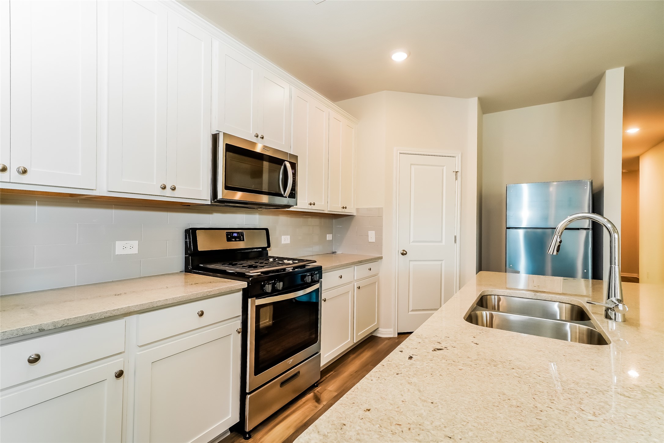 200 Babblebrook Way Hutto, TX 78634 - Photo 8 of 16 a kitchen with granite countertop a sink a stove and refrigerator