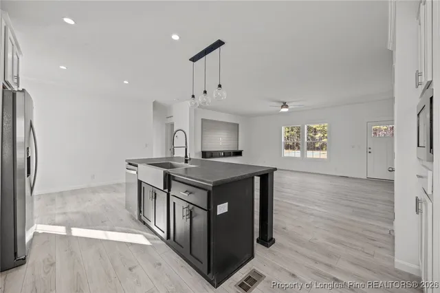 a kitchen with stainless steel appliances granite countertop a stove and a refrigerator