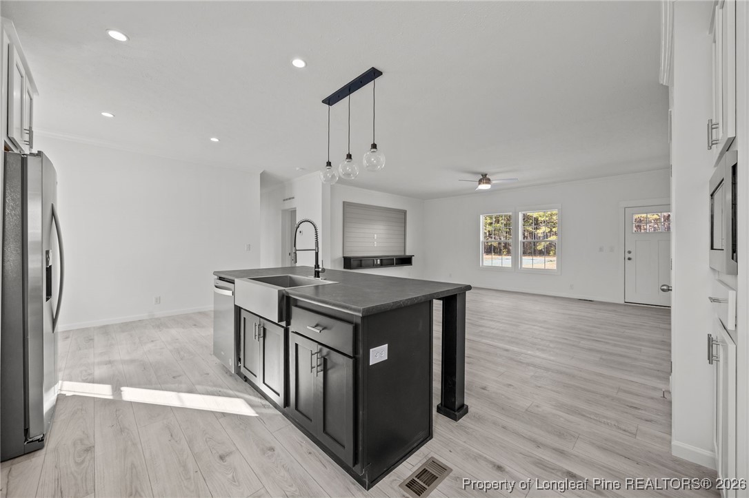849 Loop Road Bunnlevel, NC 28323 - Photo 14 of 39 a kitchen with stainless steel appliances granite countertop a stove and a refrigerator