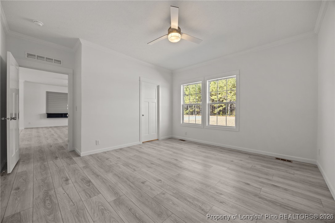 849 Loop Road Bunnlevel, NC 28323 - Photo 17 of 39 wooden floor in an empty room with a window