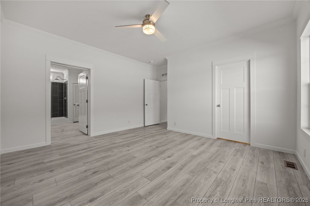 849 Loop Road Bunnlevel, NC 28323 - Photo 18 of 39 an empty room with wooden floor and windows