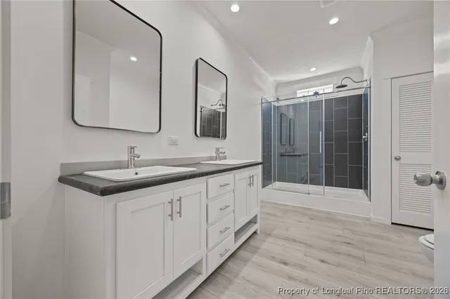 a bathroom with double sink and a shower