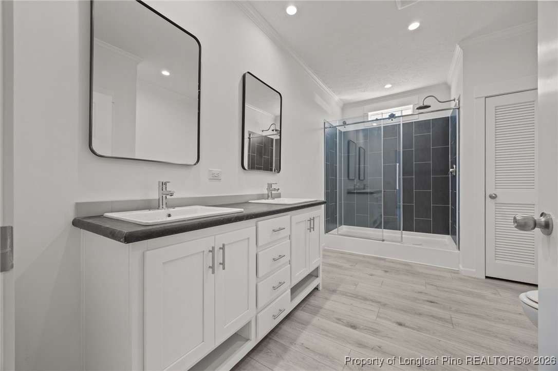 849 Loop Road Bunnlevel, NC 28323 - Photo 21 of 39 a bathroom with double sink and a shower