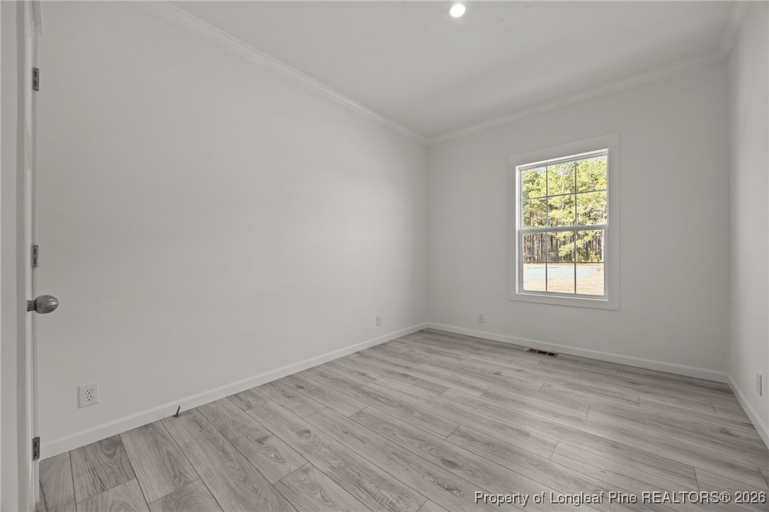 849 Loop Road Bunnlevel, NC 28323 - Photo 24 of 39 wooden floor in an empty room with a window