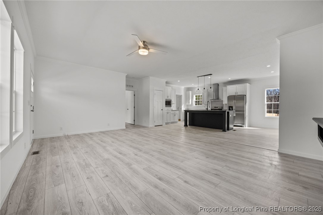 849 Loop Road Bunnlevel, NC 28323 - Photo 5 of 39 a view of a livingroom with furniture and wooden floor