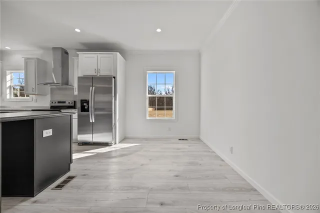 a kitchen with stainless steel appliances a refrigerator sink and cabinets