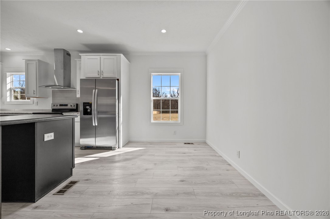 849 Loop Road Bunnlevel, NC 28323 - Photo 7 of 39 a kitchen with stainless steel appliances a refrigerator sink and cabinets