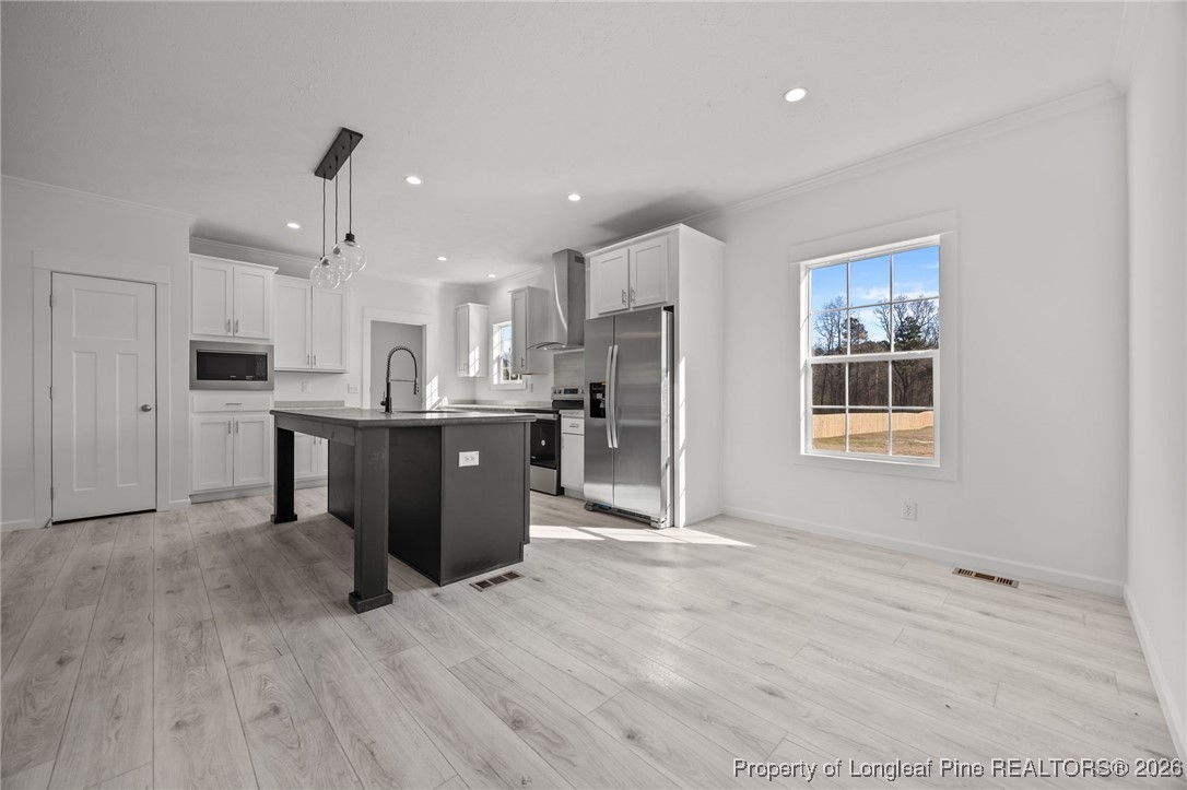 849 Loop Road Bunnlevel, NC 28323 - Photo 8 of 39 a open kitchen with stainless steel appliances granite countertop a stove a sink dishwasher and a refrigerator with wooden floor
