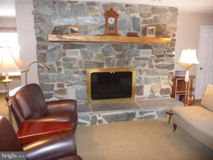 3165 Hickory Ridge Road Dunkirk, MD 20754 - Photo 2 of 30 a living room with furniture a fireplace and a flat screen tv