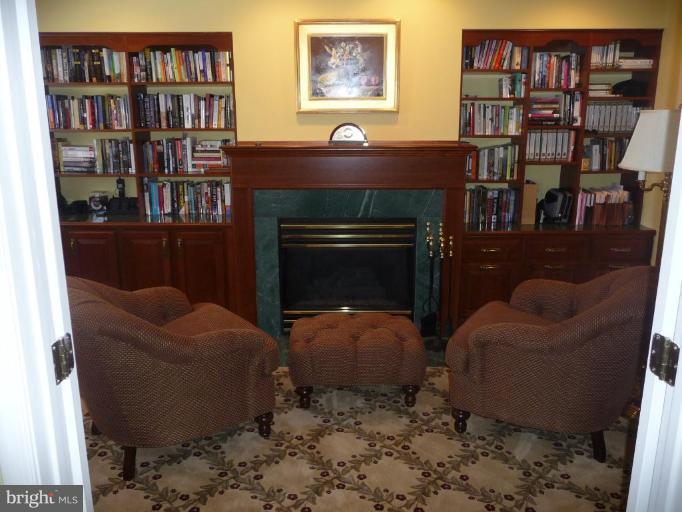 3165 Hickory Ridge Road Dunkirk, MD 20754 - Photo 17 of 30 a living room with furniture a bookshelf and a book shelf