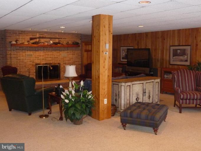 3165 Hickory Ridge Road Dunkirk, MD 20754 - Photo 19 of 30 a living room with furniture a flat screen tv and a fireplace
