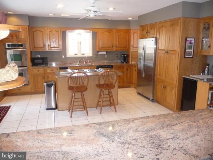 3165 Hickory Ridge Road Dunkirk, MD 20754 - Photo 3 of 30 a kitchen with stainless steel appliances kitchen island granite countertop a refrigerator a stove and a sink with granite countertops